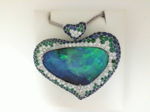 White 18 Karat Pendant-One 17.99Ct Multi-Shaped Opal 0.98Tw Round G Si1 Diamonds-1.68Tw Round Sapphires-0.50Tw Round Emeralds-0.20Tw Round Tsavorite  Serial #  575178  Style  Cable Link  Metal  18 Karat  Color  White  Length  18