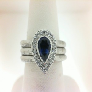 18 Karat White Gold Ring With 18=0.14Tw Round Diamonds And One 0.48Ct Pear Sapphire