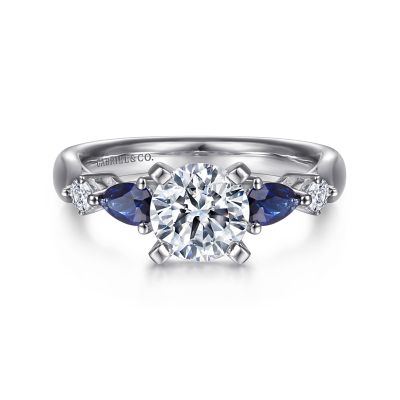 Gabriel & Co:14 Karat White Gold Semi-Mount With 2 Pear Sapphires At 0.59 Total Weight  And 2 Round G/H SI1-2 Diamonds At 0.10 Total Diamond Weight 
*Setting only, center stone not included